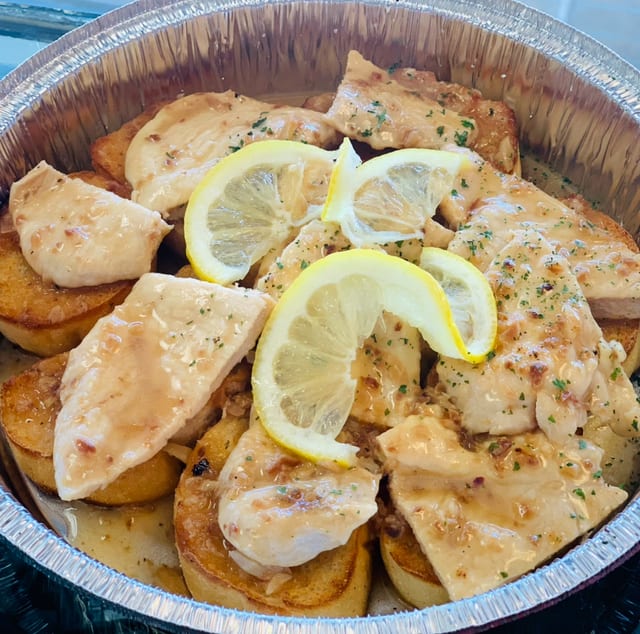 Chicken Scampi Over Garlic Bread.